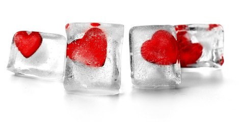 Red hearts in ice cubes isolated on white