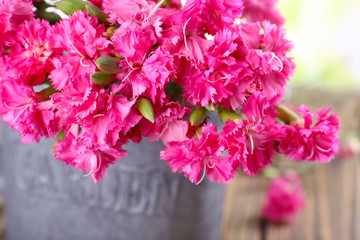 Beautiful bouquet of pink carnation in watering can close up