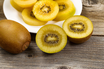 Freshly sliced golden kiwi on rustic wooden board