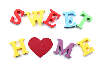 Decorative letters forming words SWEET HOME with heart isolated on white