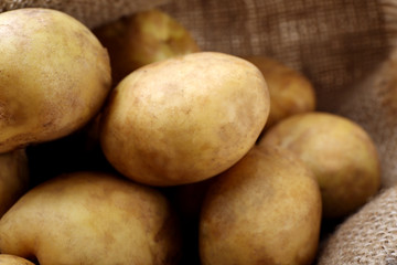 Young potatoes on sackcloth close up