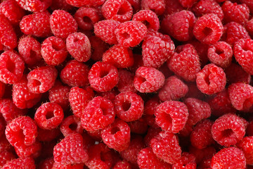 Heap of sweet red raspberries close up