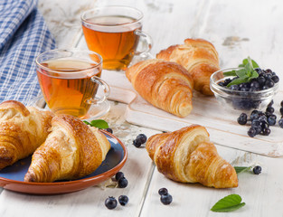 Fresh Croissants with Cups of Tea for a Breakfast.