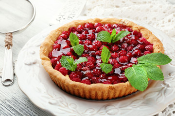 Tart with raspberries, on wooden background