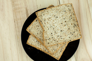 Fresh sliced wholewheat bread with various seeds and multigrain on wood background