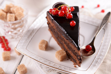 Tasty chocolate cake with berries on table close up