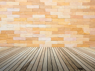 perspective wood plank floor with over blur Brick wall backgroun