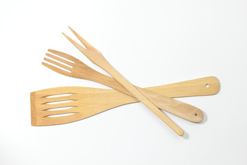 Wooden spoons, spatulas and a fork isolated on white background