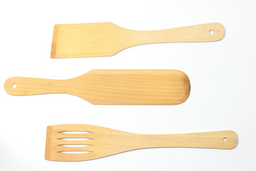 Wooden spoons, spatulas and a fork isolated on white background
