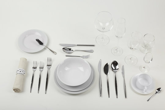 Table setting, close up, on white background