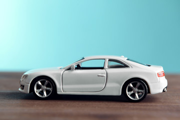 Fototapeta na wymiar Small toy car on blue background