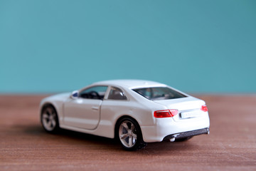 Fototapeta na wymiar Small toy car on blue background