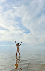 Adorable funny baby girl splashing in the water