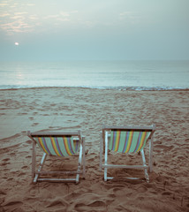 Beach sunrise with beach chairs