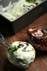 Homemade ice cream in frozen metallic container on dark wooden background