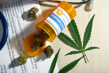 Medical prescription with dry cannabis on table close up