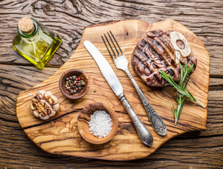 Beef steaks  with spices on a wooden tray.
