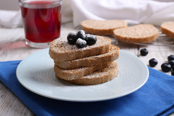 Fresh toast with berries and glass of juice on table close up
