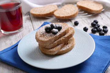 Fresh toast with berries and glass of juice on table close up