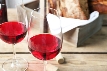 Still life of wine and bread on light background