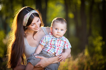 Fototapeta premium Mother keeps son in his hands