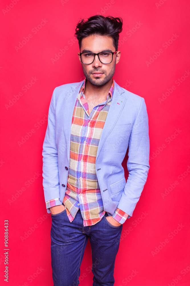 Poster young fashion man posing on red background