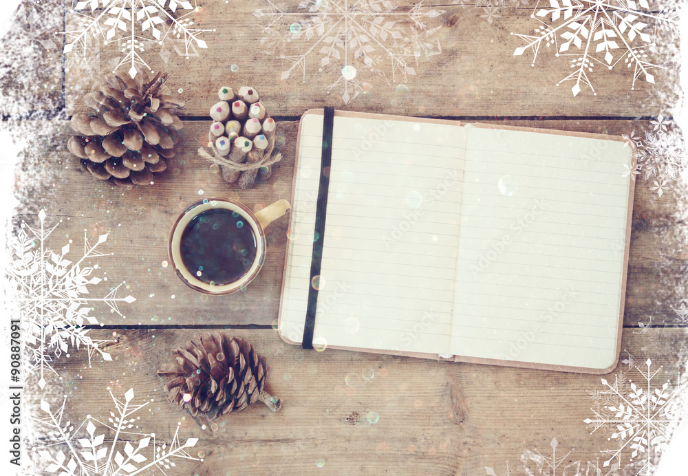 Poster top image of open notebook with blank pages, next to pine cones and cup of coffee over wooden table.