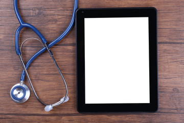 Stethoscope and digital tablet on wooden background