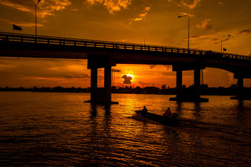 Fototapeta na wymiar Silhouetted of Bridge over the river in Thailand.