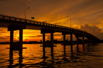 Fototapeta na wymiar Silhouetted of Bridge over the river in Thailand.