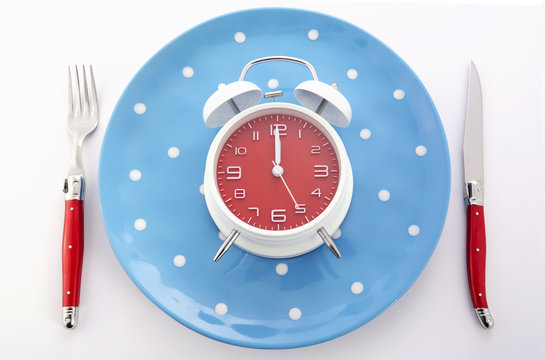 Mealtime table place setting with alarm clock