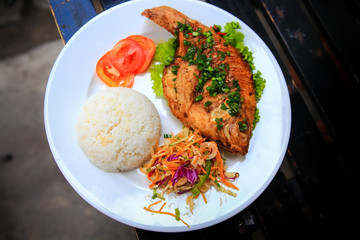 view of fried fish with rice vegetables on white plate