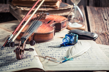 Retro sheets and violin on old wooden table