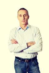 Fototapeta premium Portrait of handsome man with folded arms