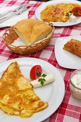 Caloric meal for two persons. Scrambled eggs, bread and salad.