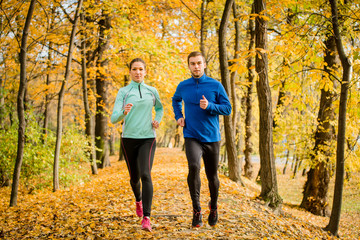 Fototapeta premium Couple jogging in autumn nature