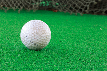 Golf ball ont the glass and blur background.