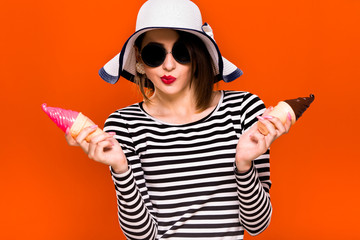 Beautiful young girl is posing with two plastic ice cream