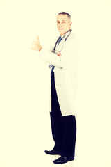 Mature male doctor with thumb up