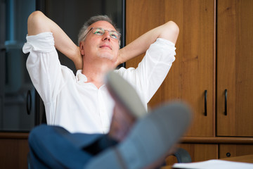 Man relaxing in his office after work