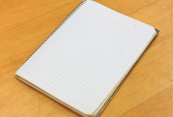 notebook on wood background.