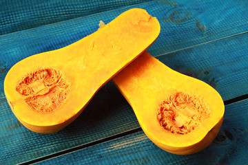 Muscat pumpkin on blue rustic background. Seasons, autumn vegetables