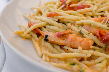 Strozzapreti with shrimp and tomatoes cherry, italian dish