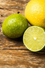 Fresh and juicy lemons and lime on a wooden surface