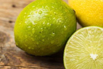 Fresh and juicy lemons and lime on a wooden surface