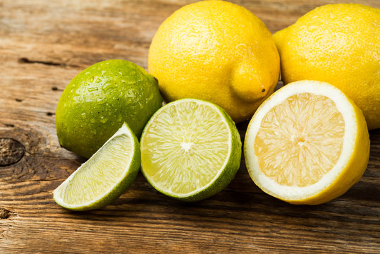 Fresh and juicy lemons and lime on a wooden surface