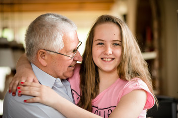 Grandfather and granddaghter hug