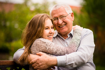 Grandfather and grandchild hug