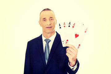 Elegant man with four aces