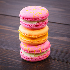 Colorful macarons on a wooden background